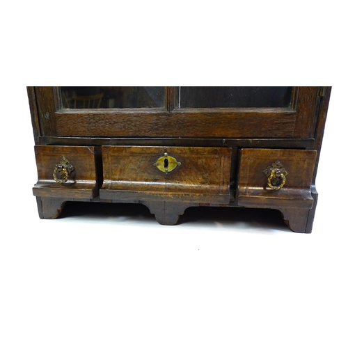 1442 - A late Georgian table top cabinet with an astragal glazed door above three short drawers raised on s... 