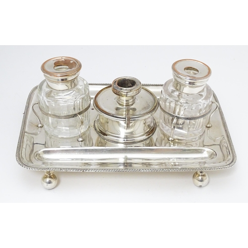 634 - Silver plate : A 19thC Old Sheffield Plate inkstand / standish with central taper / wax jack contain... 