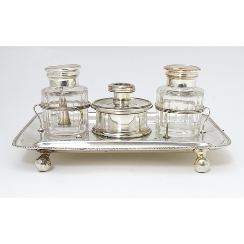 634 - Silver plate : A 19thC Old Sheffield Plate inkstand / standish with central taper / wax jack contain... 