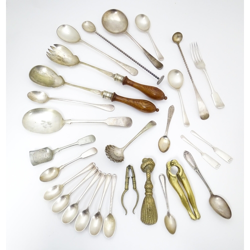 636 - A quantity of brass and silver plate ware to include various spoons, salad servers, nutcrackers to i... 