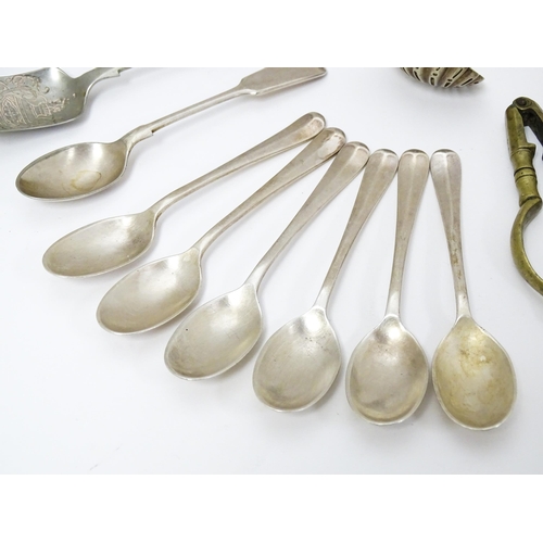 636 - A quantity of brass and silver plate ware to include various spoons, salad servers, nutcrackers to i... 