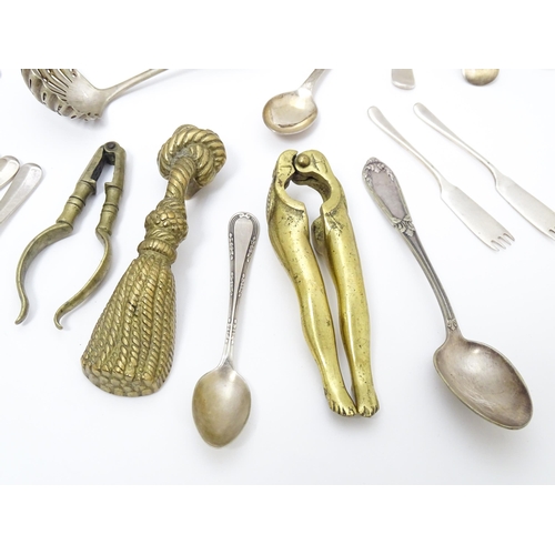 636 - A quantity of brass and silver plate ware to include various spoons, salad servers, nutcrackers to i... 