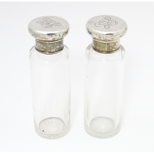 416 - A pair of glass dressing table jars with silver lids, hallmarked London 1906. Approx. 5