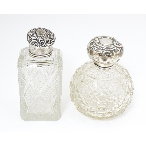 454 - A cut glass silver dressing table bottle of squared form with embossed silver lid.  Together with a ... 