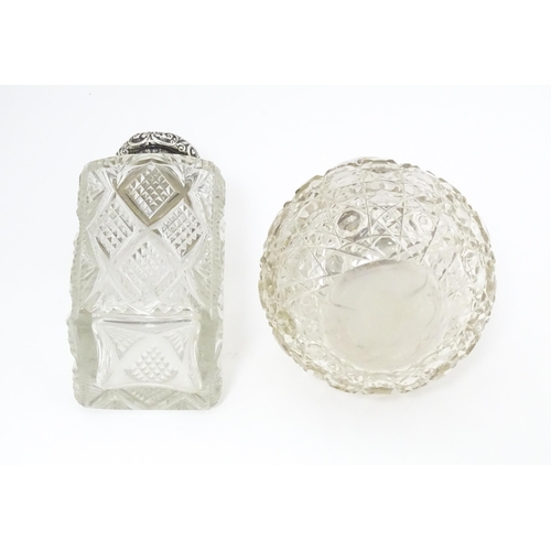 454 - A cut glass silver dressing table bottle of squared form with embossed silver lid.  Together with a ... 