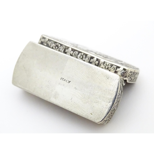 457 - An Italian white metal pill box of rectangular form with embossed decoration. Marked Italy under. Ap... 