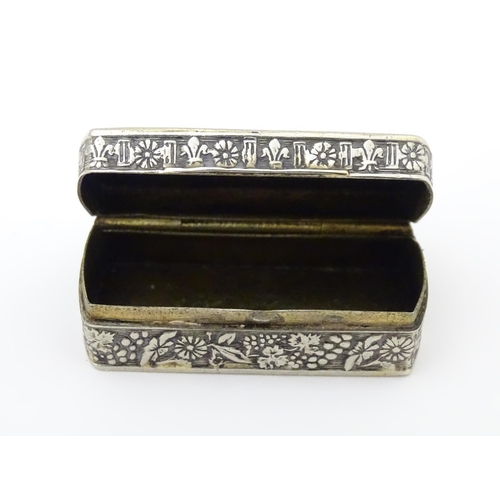 457 - An Italian white metal pill box of rectangular form with embossed decoration. Marked Italy under. Ap... 