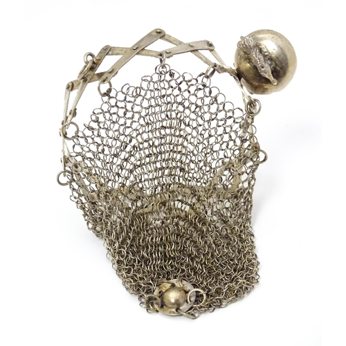 458 - A white metal purse with chain mesh body and stylised animal detail to top. Approx 3 1/2