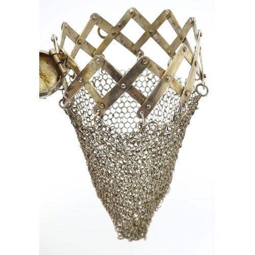 458 - A white metal purse with chain mesh body and stylised animal detail to top. Approx 3 1/2