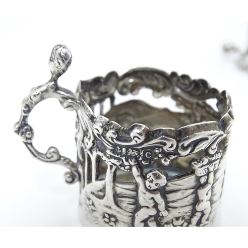 460 - A pair of miniature silver cup sleeves / tot glass holders with embossed and pierced decoration, hal... 