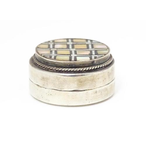 461 - An Egyptian white metal pill box set with onyx and mother of pearl detail. 1/4