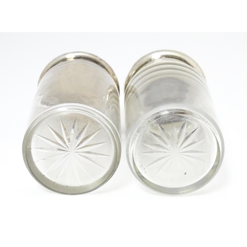 462 - Two glass dressing table jars with silver lids, hallmarked London 1906. Largest approx. 3 1/2