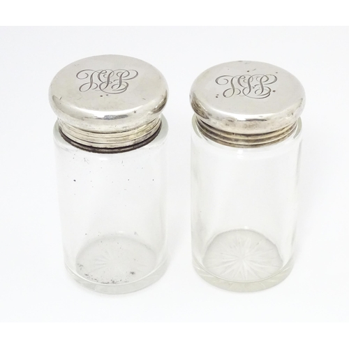 462 - Two glass dressing table jars with silver lids, hallmarked London 1906. Largest approx. 3 1/2