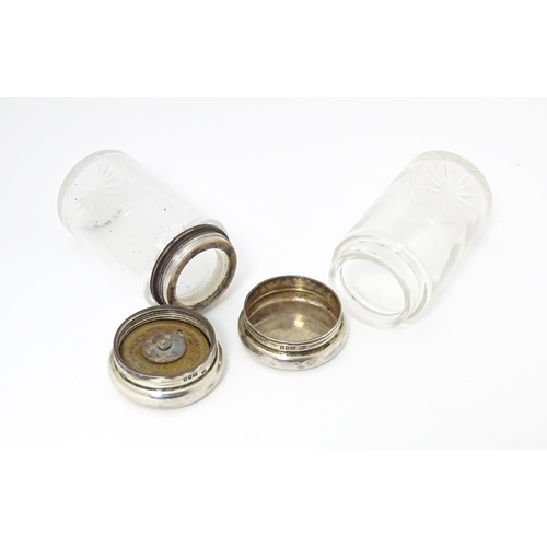 462 - Two glass dressing table jars with silver lids, hallmarked London 1906. Largest approx. 3 1/2