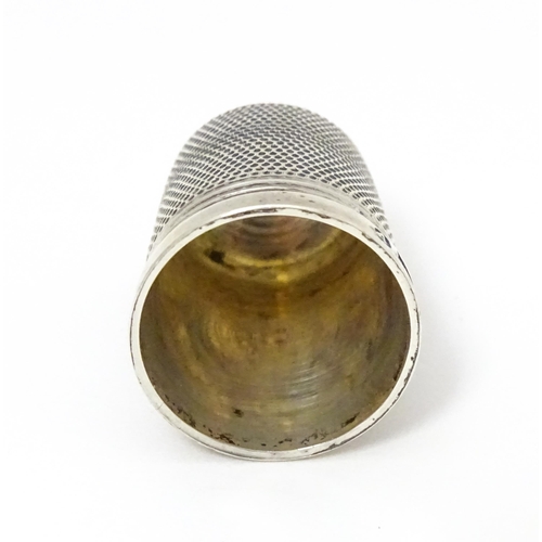 464 - A silver thimble hallmarked 1972 maker James Swann & Son together with a silver folding fruit knife ... 