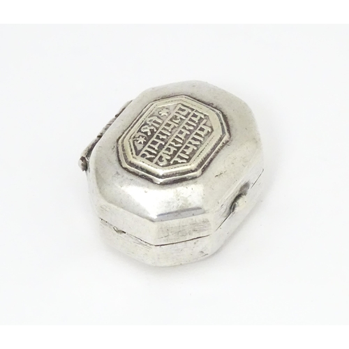 479 - A Continental white metal pill box of octagonal form with script to lid. Approx. 1