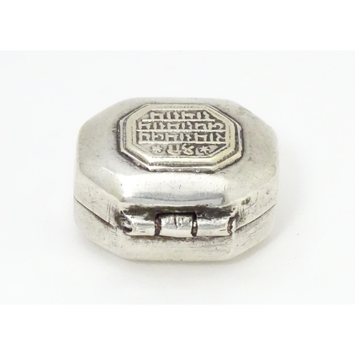 479 - A Continental white metal pill box of octagonal form with script to lid. Approx. 1