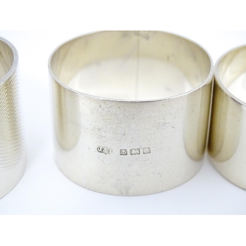 492 - Five assorted silver napkin rings to include examples hallmarked London 1937, maker S. J. Rose & Son... 