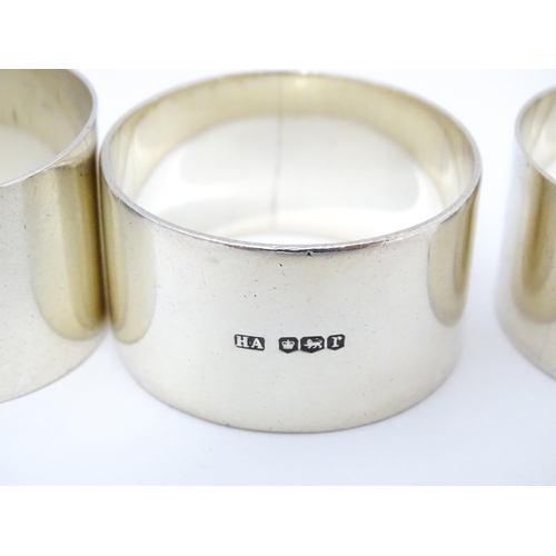 492 - Five assorted silver napkin rings to include examples hallmarked London 1937, maker S. J. Rose & Son... 