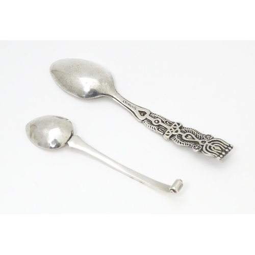 502 - A white metal Arts & Crafts teaspoon with hammered bowl and scroll detail to handle. Together with a... 