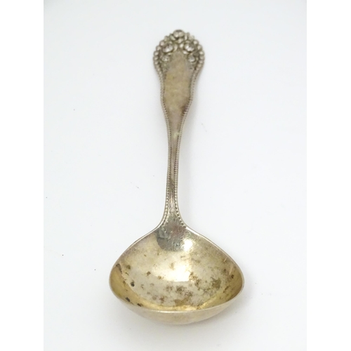 506 - Assorted silver items to include a silver handled cake knife, an American silver sauce ladle, variou... 