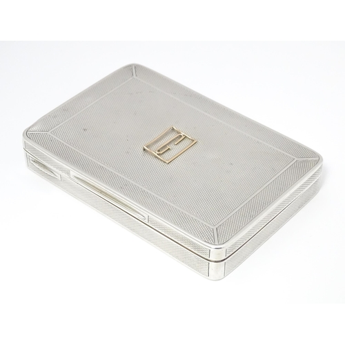 455 - A silver cigarette box with engine turned decoration and gilded interior, hallmarked London 1913, ma... 