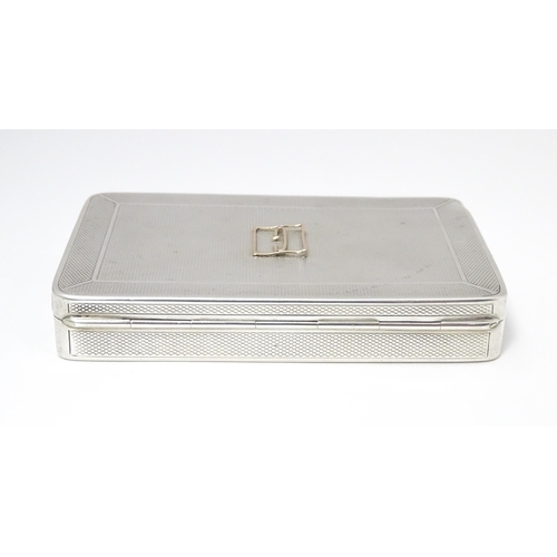 455 - A silver cigarette box with engine turned decoration and gilded interior, hallmarked London 1913, ma... 