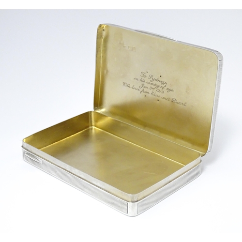 455 - A silver cigarette box with engine turned decoration and gilded interior, hallmarked London 1913, ma... 