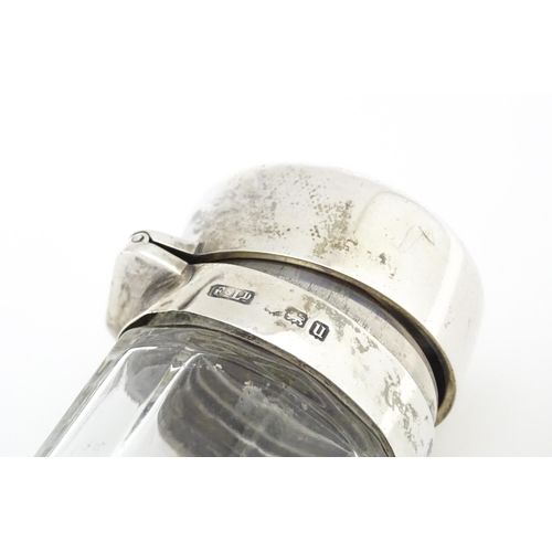 477 - A glass dressing table jar with silver top hallmarked Birmingham 1919, maker Finnigans. Approx. 6 3/... 