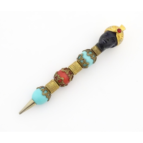 1183 - A propelling pencil with blackamoor and turquoise bead detail. Stamped Florenza. Approx. 4