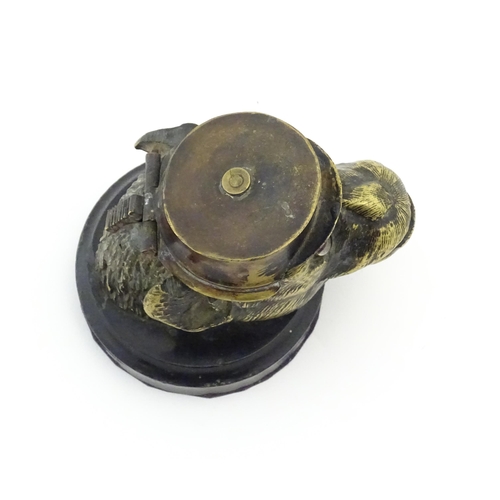 1192 - A Victorian novelty brass desk inkwell formed as the head of a monkey with glass eyes wearing a hat.... 