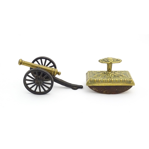 1193 - A late 20thC model desk cannon. Together with a Victorian desk blotter with cast brass detail to han... 