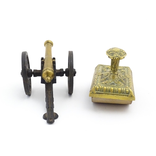 1193 - A late 20thC model desk cannon. Together with a Victorian desk blotter with cast brass detail to han... 