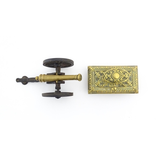 1193 - A late 20thC model desk cannon. Together with a Victorian desk blotter with cast brass detail to han... 