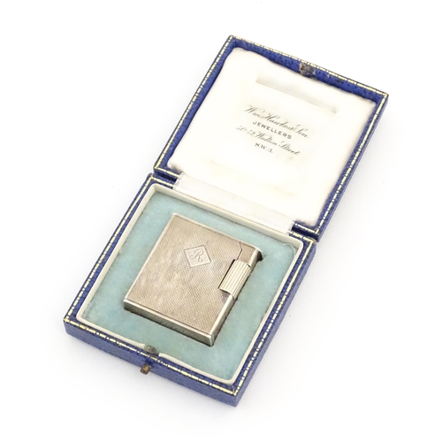 1197 - A cased Art Deco style silver pocket lighter with engine turned decoration, hallmarked 1950 London M... 