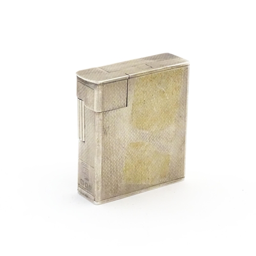 1197 - A cased Art Deco style silver pocket lighter with engine turned decoration, hallmarked 1950 London M... 