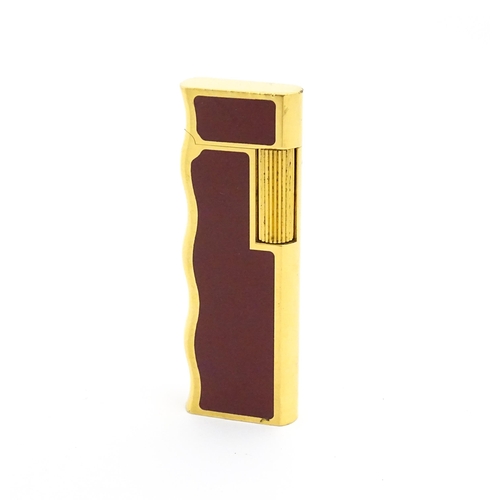 1198 - A late 20thC gold plated pocket lighter by Van Cleef & Arpels with burgundy enamel detail, stamped u... 