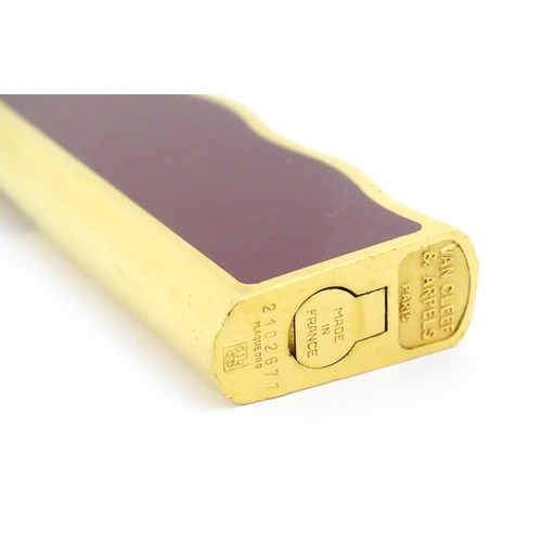 1198 - A late 20thC gold plated pocket lighter by Van Cleef & Arpels with burgundy enamel detail, stamped u... 