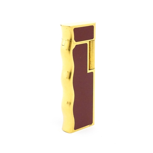 1198 - A late 20thC gold plated pocket lighter by Van Cleef & Arpels with burgundy enamel detail, stamped u... 