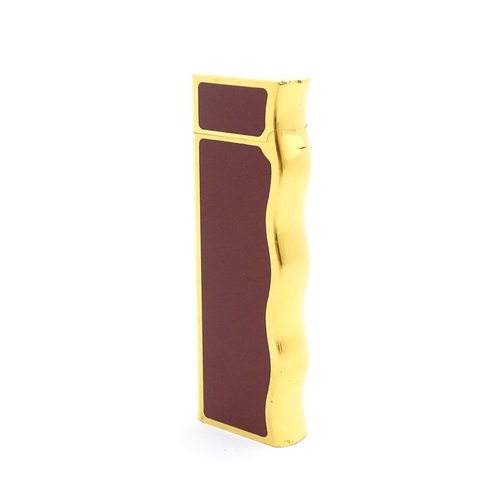 1198 - A late 20thC gold plated pocket lighter by Van Cleef & Arpels with burgundy enamel detail, stamped u... 