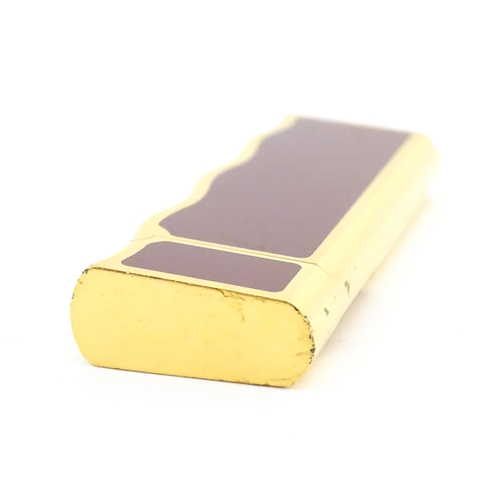 1198 - A late 20thC gold plated pocket lighter by Van Cleef & Arpels with burgundy enamel detail, stamped u... 