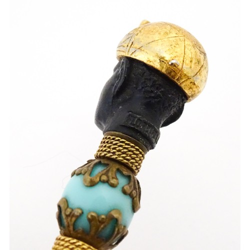 1183 - A propelling pencil with blackamoor and turquoise bead detail. Stamped Florenza. Approx. 4