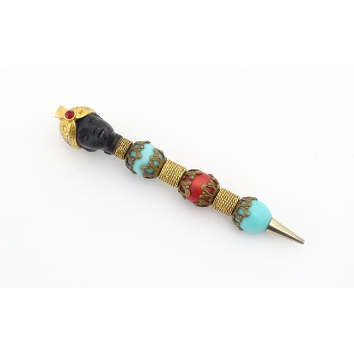 1183 - A propelling pencil with blackamoor and turquoise bead detail. Stamped Florenza. Approx. 4