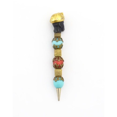 1183 - A propelling pencil with blackamoor and turquoise bead detail. Stamped Florenza. Approx. 4