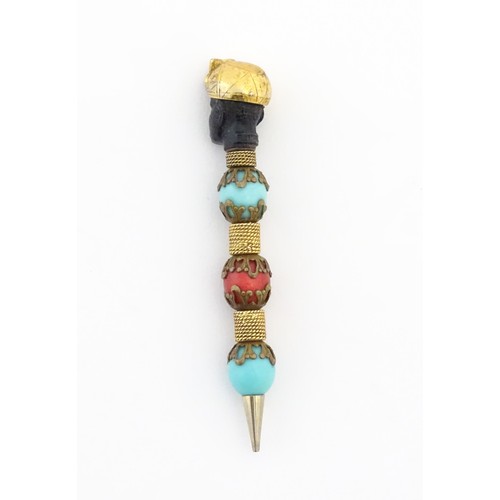 1183 - A propelling pencil with blackamoor and turquoise bead detail. Stamped Florenza. Approx. 4