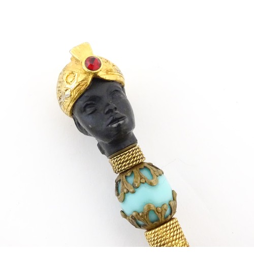 1183 - A propelling pencil with blackamoor and turquoise bead detail. Stamped Florenza. Approx. 4