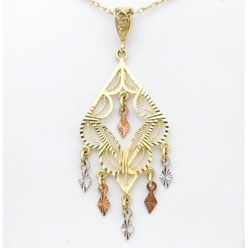 704 - A 9ct gold pendant with filigree detail on a 9ct gold chain. The pendant approx 2