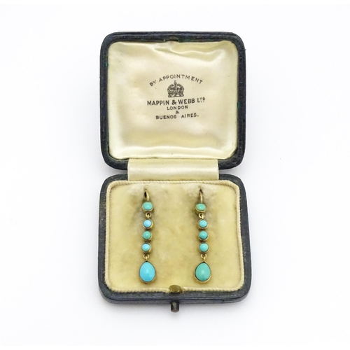 713 - A pair of gold drop earrings set with turquoise. 1 1 /4