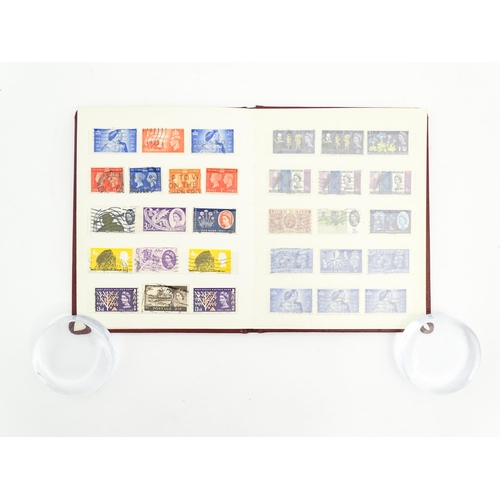 1999 - A stamp album containing a quantity of British postage stamps, including Victorian examples: Penny B... 