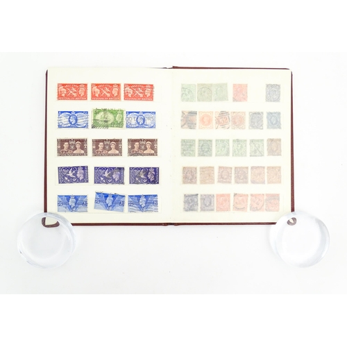 1999 - A stamp album containing a quantity of British postage stamps, including Victorian examples: Penny B... 